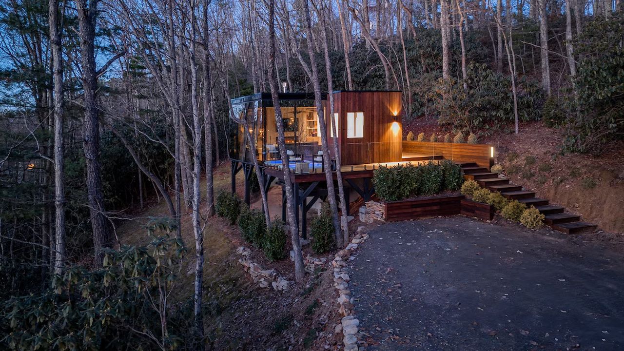 Glass-walled hilltop lounge looking into the trees
